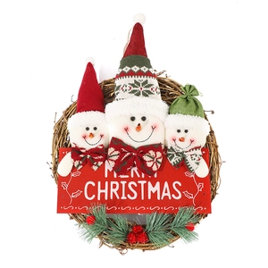 Christmas wreath with three cute snowmen, Merry Christmas sign and pine needles on rattan ring