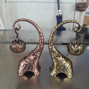 Detail of hanging elephant incense burner with lotus holder in bronze and copper finish