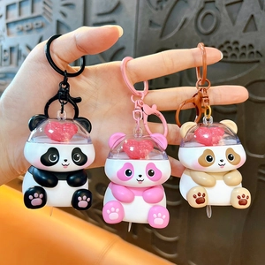 Three cute glowing panda keychains with hearts for bags or car keys in multiple colors
