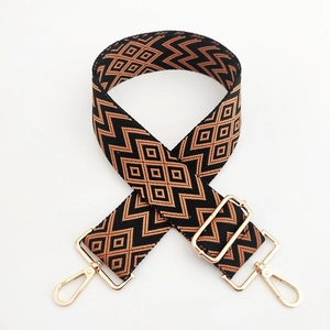 Detail of adjustable 5cm wave pattern bag strap with gold rotating hooks and buckles