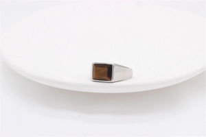 Detailed macro view of a vintage square tiger eye gemstone set in a silver steel ring