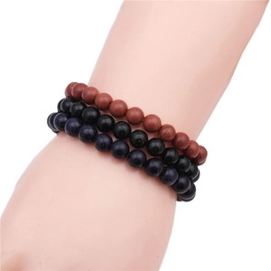Detail of 8mm beaded bracelets set featuring brown goldstone, black beads, and blue goldstone
