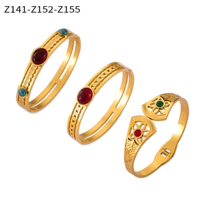 Detailed view of three vintage gold-plated titanium steel bangles with natural stones