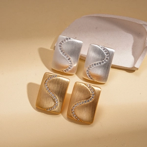 Matte gold and silver rectangular stud earrings with S-shaped zircon inlay detail