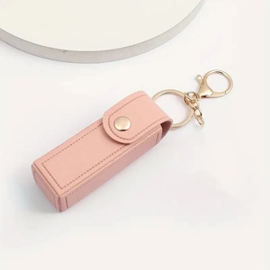 Detail of pink pebbled leather lipstick keychain holder with gold snap and lobster clasp