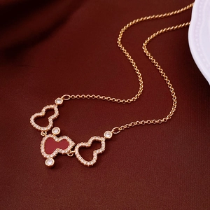 18K gold plated necklace with hollow gourd pendant and red inlay on deep red fabric