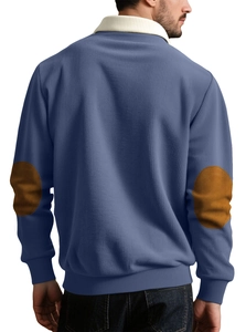Detail view of the brown elbow patches and navy blue ribbed texture on casual knit sweater
