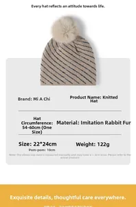 Close-up of khaki winter beanie featuring silver stripe sequins and a large faux fur pompom