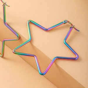 Rainbow iridescent stainless steel star hoop earrings on beige geometric display pedestal