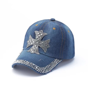 Denim baseball cap featuring a rhinestone cross and vintage washed finish detail