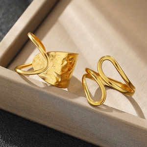 Macro shot of gold-plated hammered texture and double-layered hollow stainless steel rings