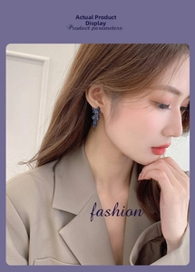 Close-up of sparkling blue fox stud earrings on a model showing refined S925 style
