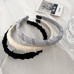 Three-piece fabric padded headband set in black, beige, and grey with fringe edges