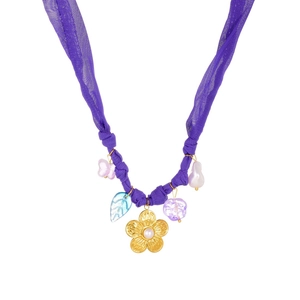 Detail of floral gold pendant with baroque pearl and vintage ribbon chain necklace