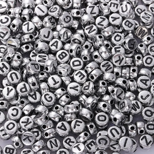 Macro shot of silver round acrylic alphabet beads for DIY creative jewelry making
