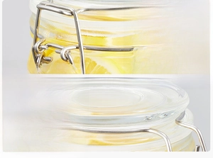 Close-up of airtight glass storage jar with stainless steel buckle and lemon slices