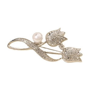 Elegant silver tulip flower brooch with sparkling crystals and a white pearl on white background