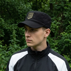 Tactical black flat top military cap with US embroidery patch shown on outdoor model