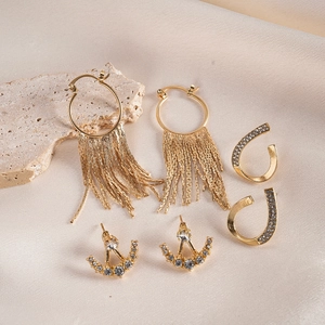 Detailed view of six-piece gold earrings set featuring tassels and rhinestone geometric shapes