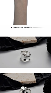 Macro shot of 925 sterling silver ring with origami texture and polished irregular folds