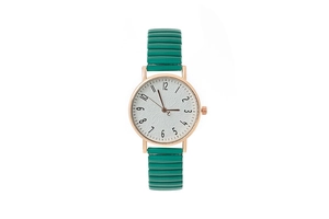 Detail of quartz watch with green elastic strap, rose gold case, and white dial