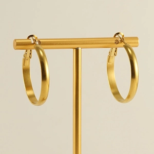 Minimalist 18k gold plated stainless steel hoop earrings on a T-shaped display stand