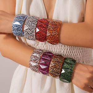 Detail view of colorful leopard print acrylic wide bracelets with geometric facets