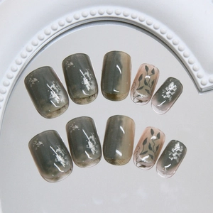 Green leaf marble pattern short square press-on nails with silver foil on mirror stand