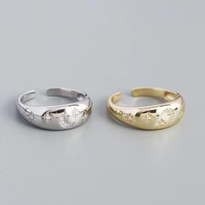 Detailed close-up of adjustable silver and gold star and moon rings with zircon accents