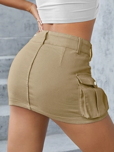 Detailed view of khaki utility mini skirt featuring large side pockets and cotton texture