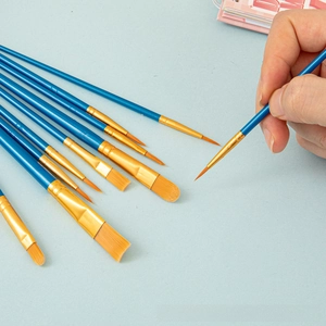 Detail of 10 nylon hair paint brushes with blue handles and gold ferrules for acrylics