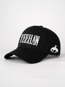 Close-up of black cotton baseball cap with white YEEHAW embroidery and cowboy silhouette