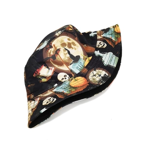 Detail of Halloween bucket hat featuring pumpkin, bat, and skull all-over print design