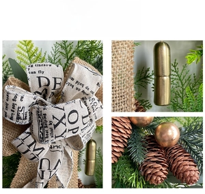 Close-up of Christmas wreath details showing burlap bow and pine cones