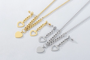 Detail of gold and silver heart-shaped necklace and earrings set with hollow design
