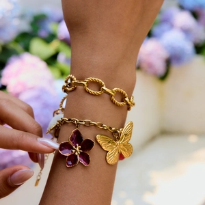 Elegant gold-plated stainless steel bracelet featuring purple enamel flowers and butterfly