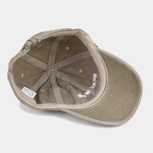 Detail view of cotton baseball cap interior showing 100% cotton label and reinforced stitching