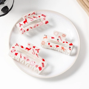 Three cute Christmas themed acrylic hair claws with reindeer and snowman prints
