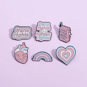 Set of 6 transgender rights enamel pins with pink and blue gradient heart and milk box designs