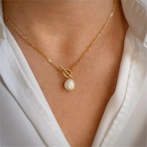 Close-up of golden OT toggle clasp necklace with a baroque freshwater pearl pendant