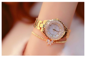 Close-up of gold women's watch with rhinestones and matching bow bracelet set