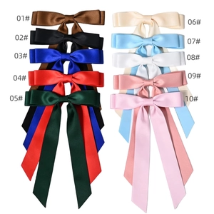 Double-layered satin ribbon bow hair clips in ten vibrant colors for women's hairstyling