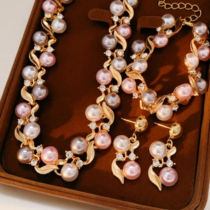 Détail d'un ensemble de bijoux vintage avec perles et strass dans un coffret en velours