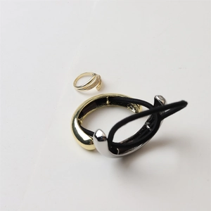 Detail of high-quality gold crystal ring and minimalist metal hair ties on white background