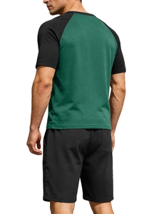 Close-up of breathable knit fabric on green raglan sleeve and black sports shorts