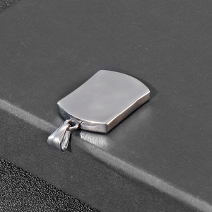 Close-up of a silver titanium steel rectangular pendant with a smooth polished finish