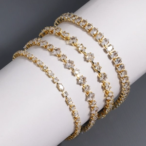 Detail of four gold-plated tennis bracelets with round, square, marquise and pear cut zircons