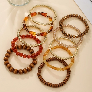 Detailed shot of multi-layer bohemian stretch bracelets with amber resin and gold beads