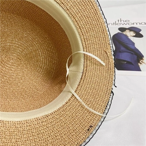 Detail of straw hat inner band with adjustable drawstring and fine woven texture