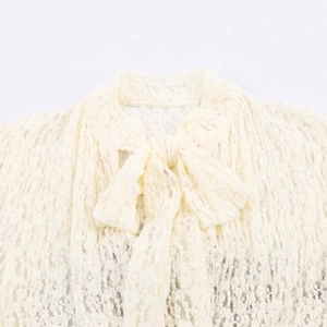 Short jumpsuit with cream lace texture and a chic bow-tie neckline detail